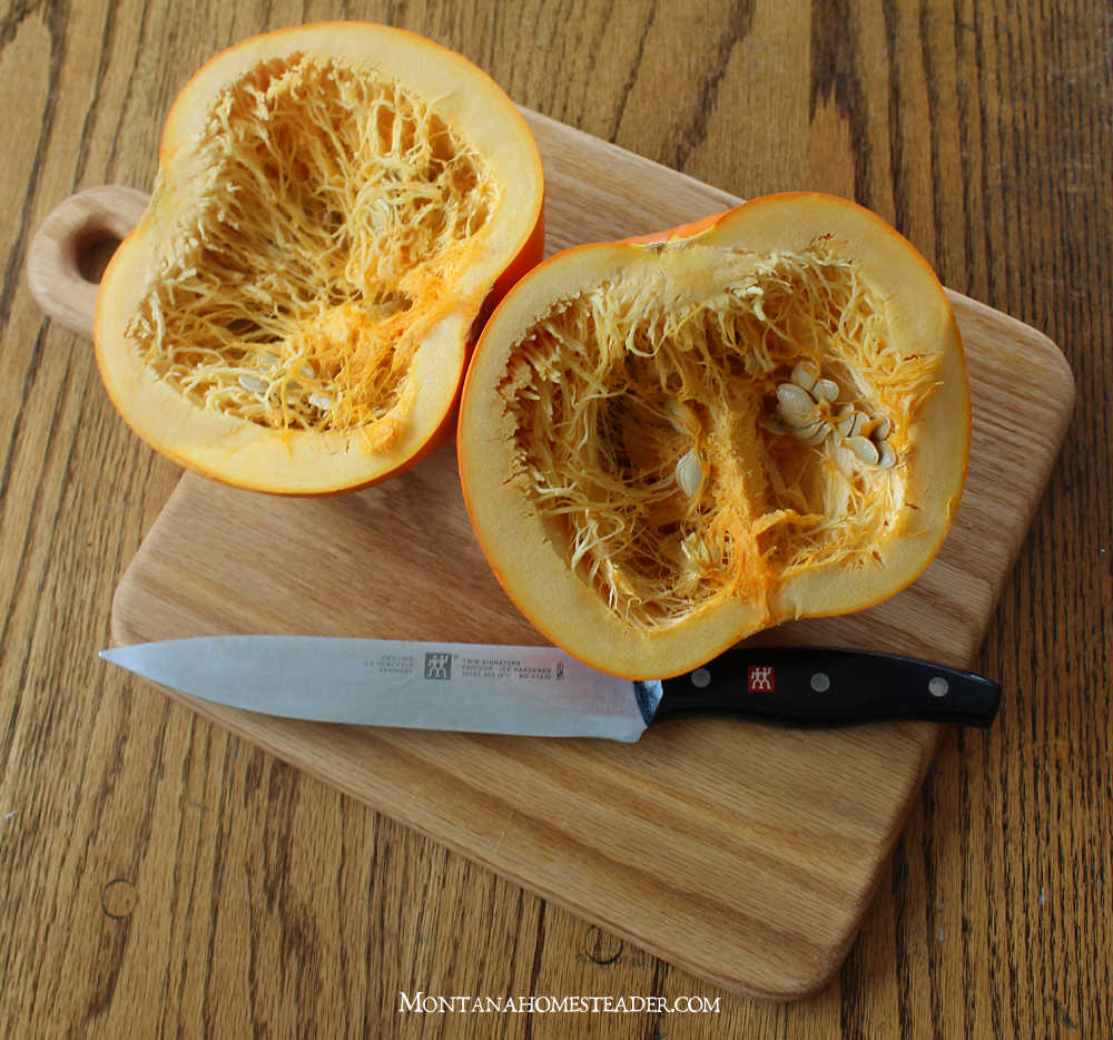 How to clean pumpkin winter squash seeds to make roasted pumpkin seeds pumpkin cut in half with big sharp knife sitting on wood board
